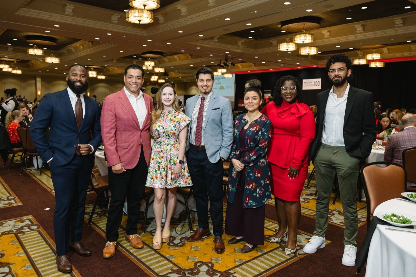 Brillion Studio team and guests posed at their Cougar 100 table