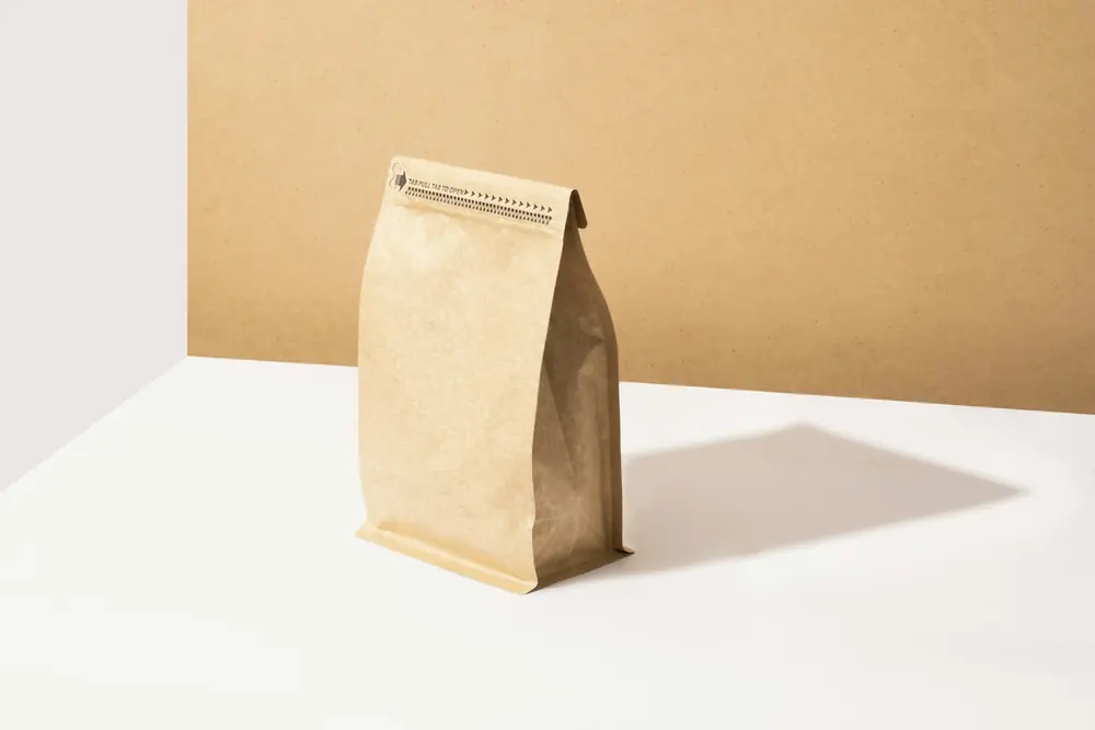 A plain paper coffee bag on a white table