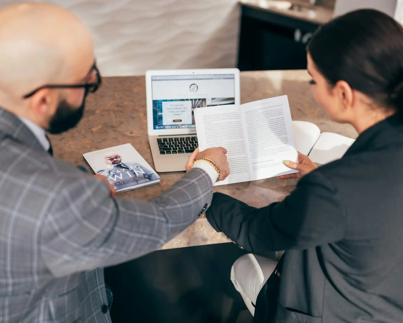 An advisor walking a client through a report at a table
