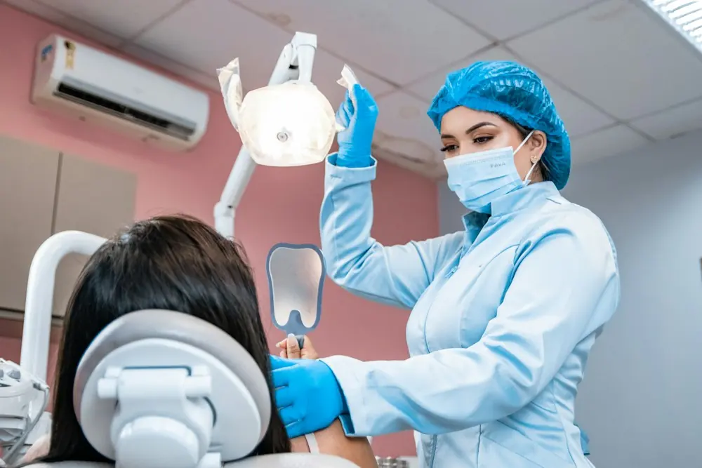 A hygienist cleaning a patient's teeth