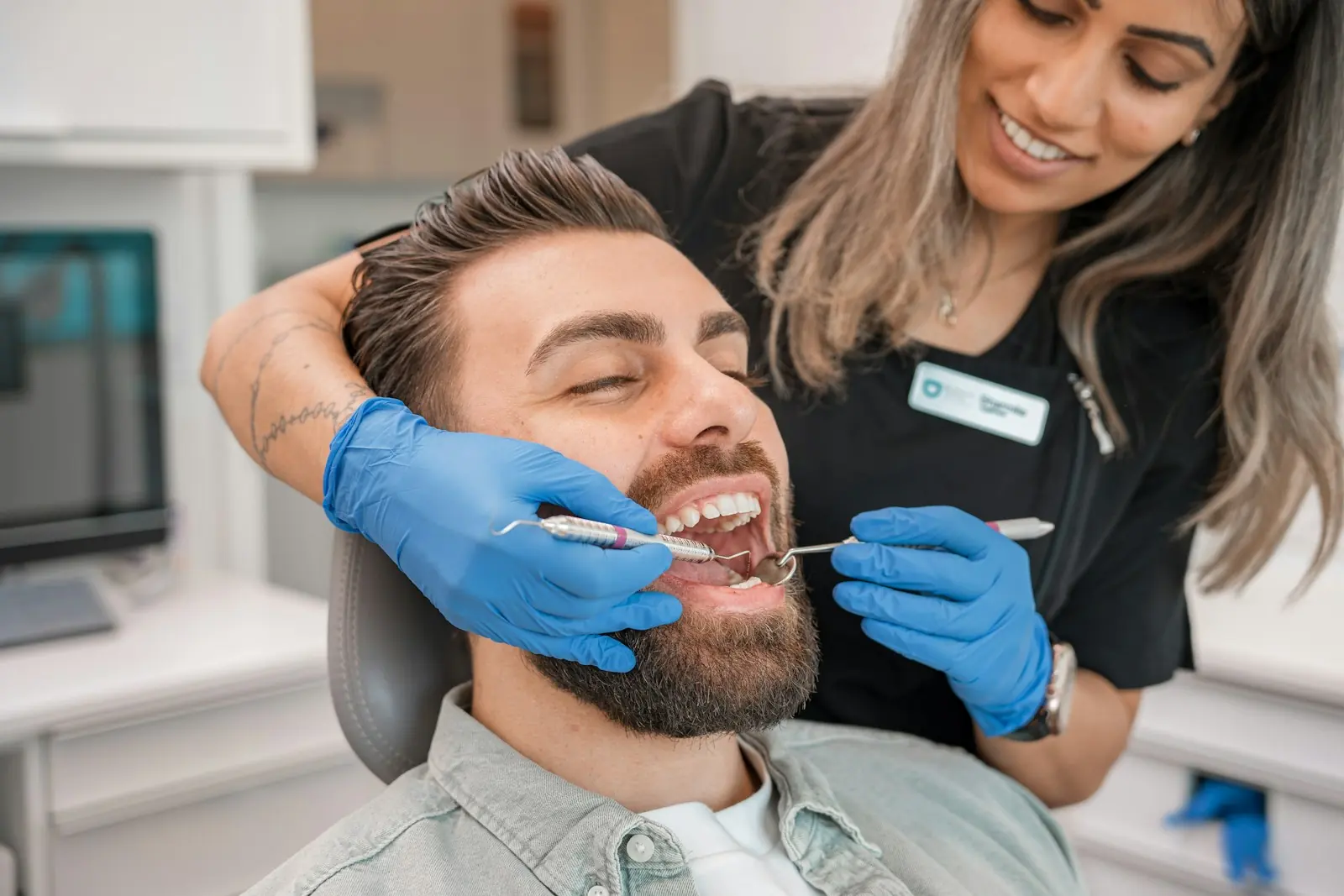 A dentist and a smiling patient during a consult