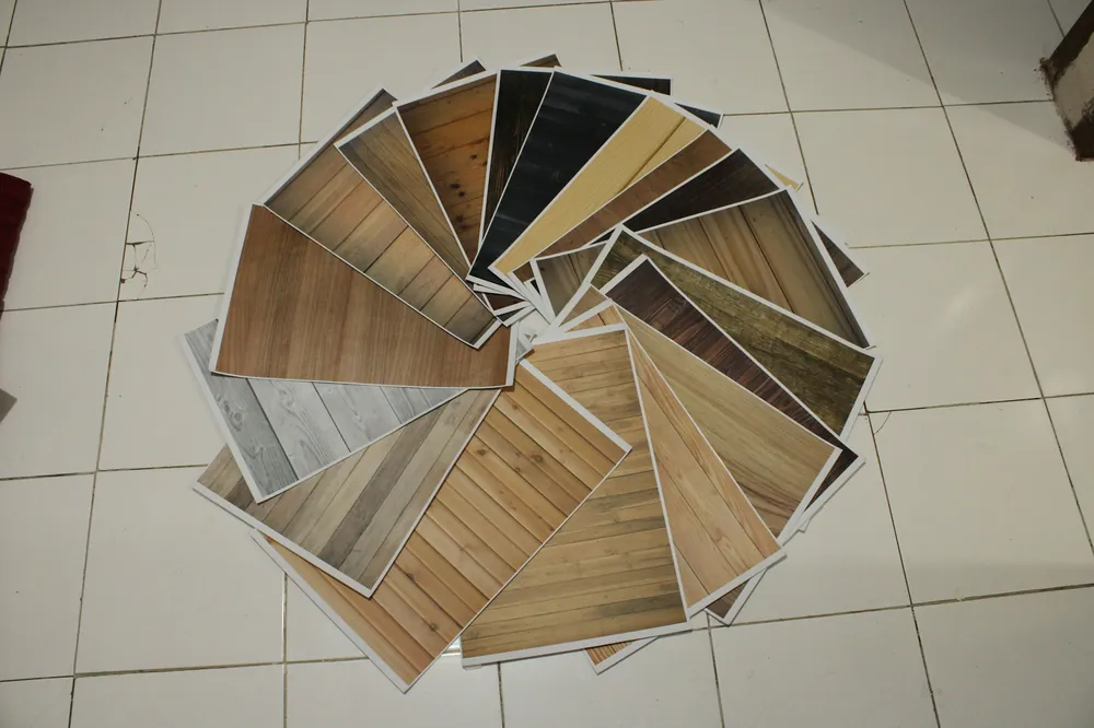 Flooring samples fanned out on a tiled floor