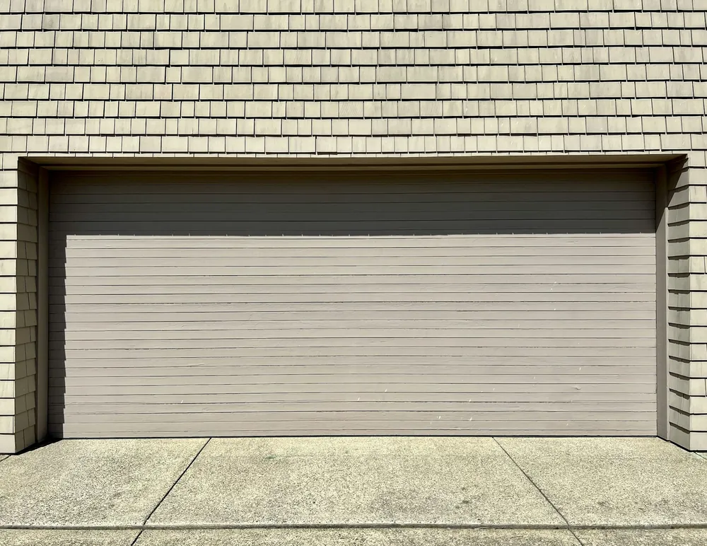 A plain beige garage door, closed