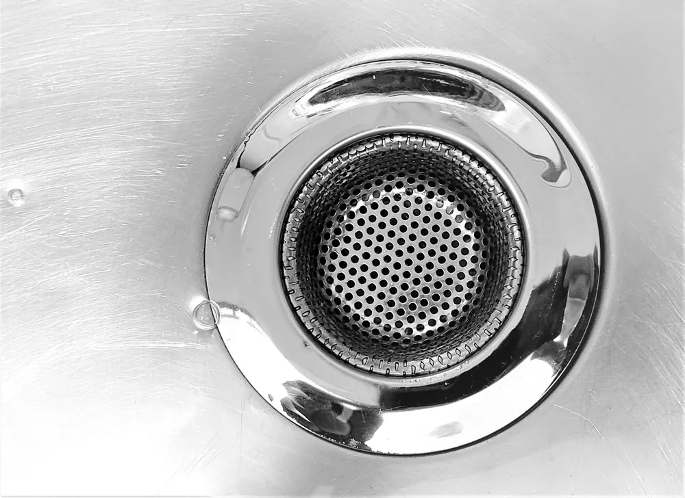 A steel sink drain strainer, close up