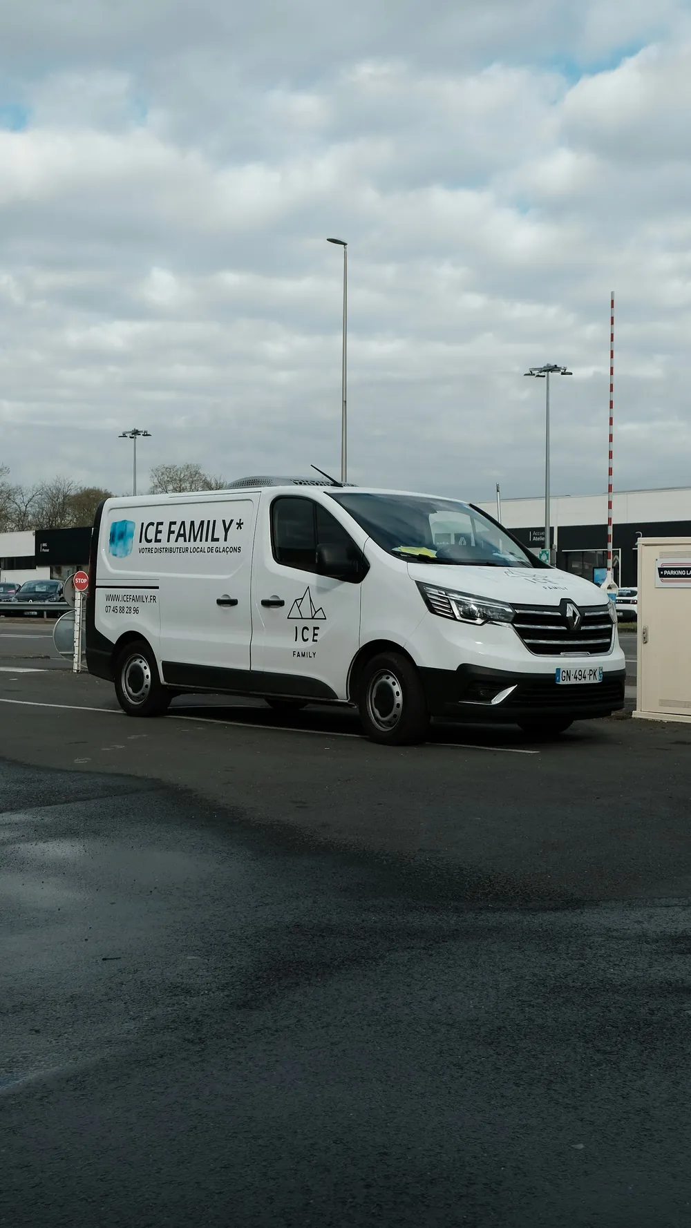 A white service van parked alone in a wide lot