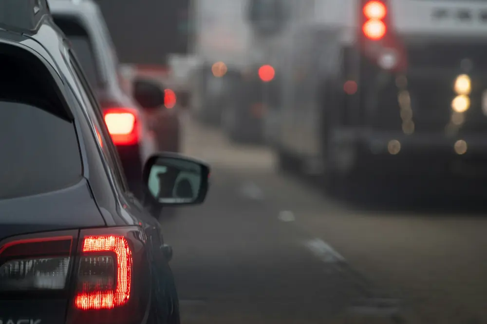 Brake lights in slow traffic on a grey evening