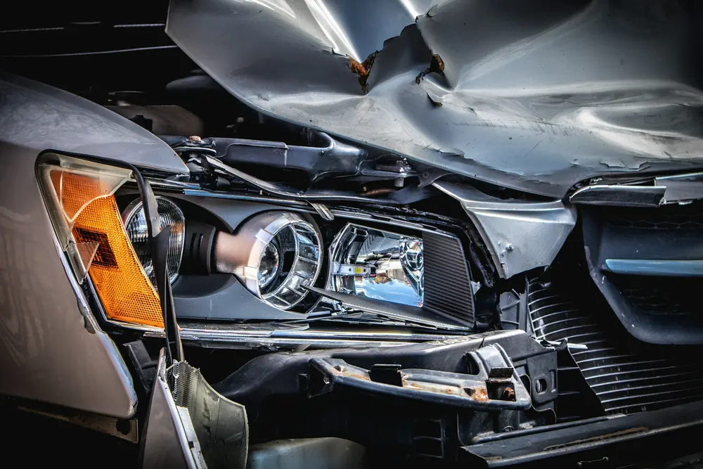 The crumpled front of a car after a collision