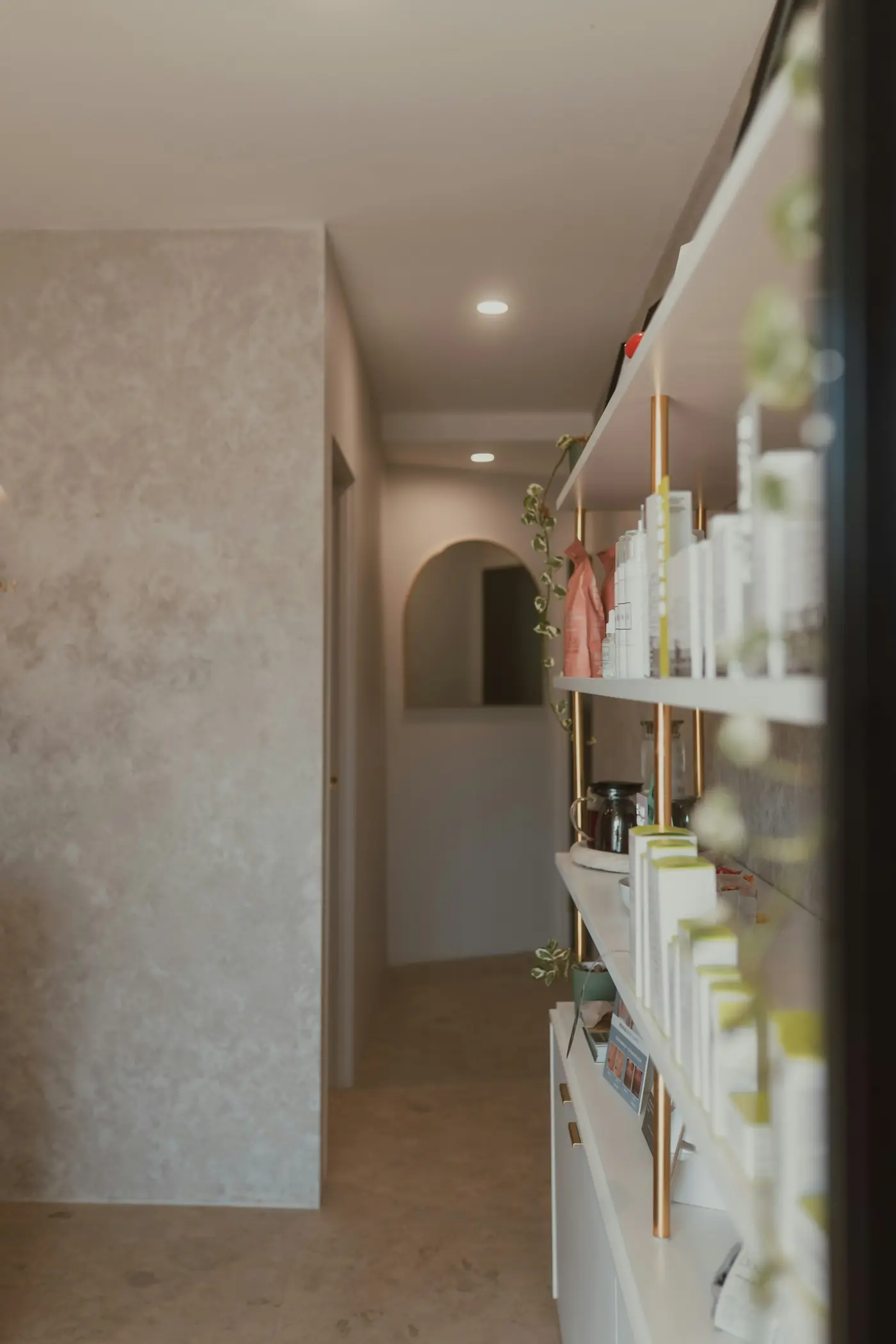 A bright corridor lined with shelves of skincare