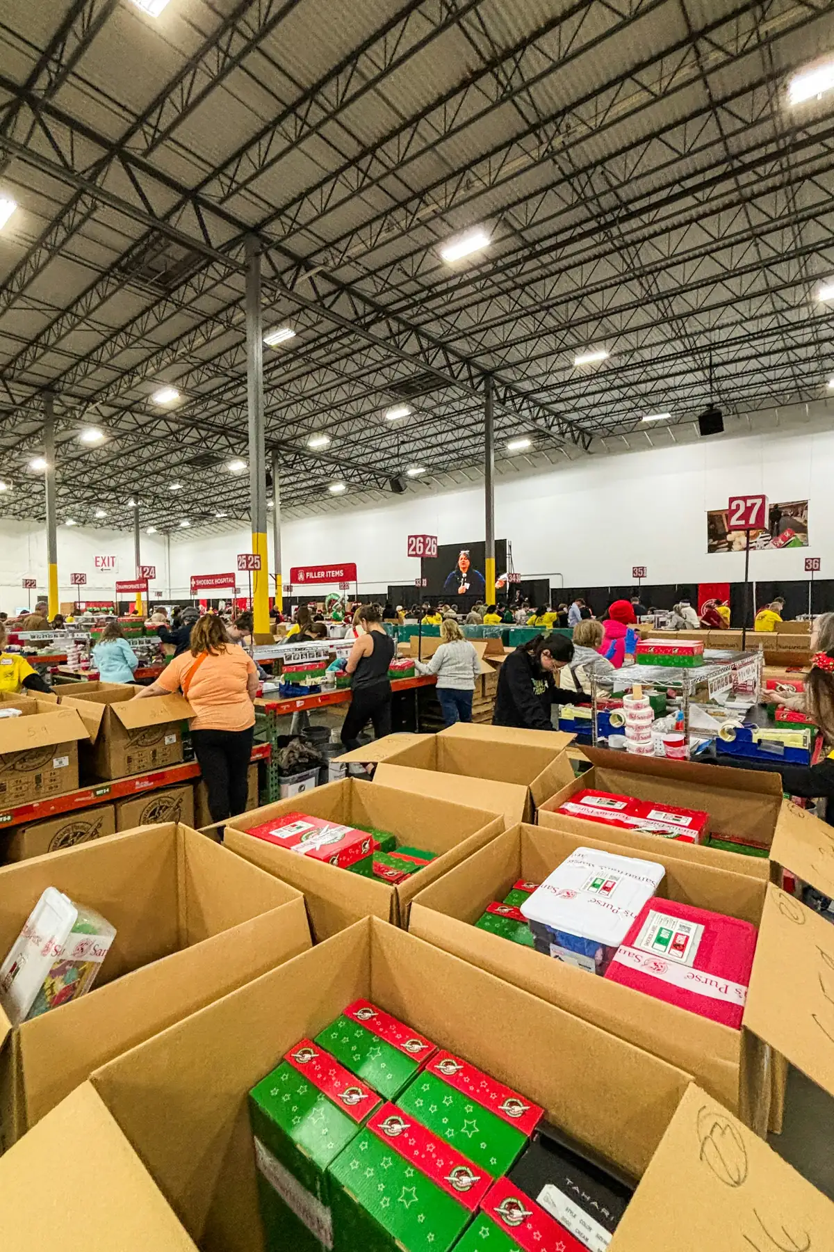 A warehouse floor of open relief boxes being packed