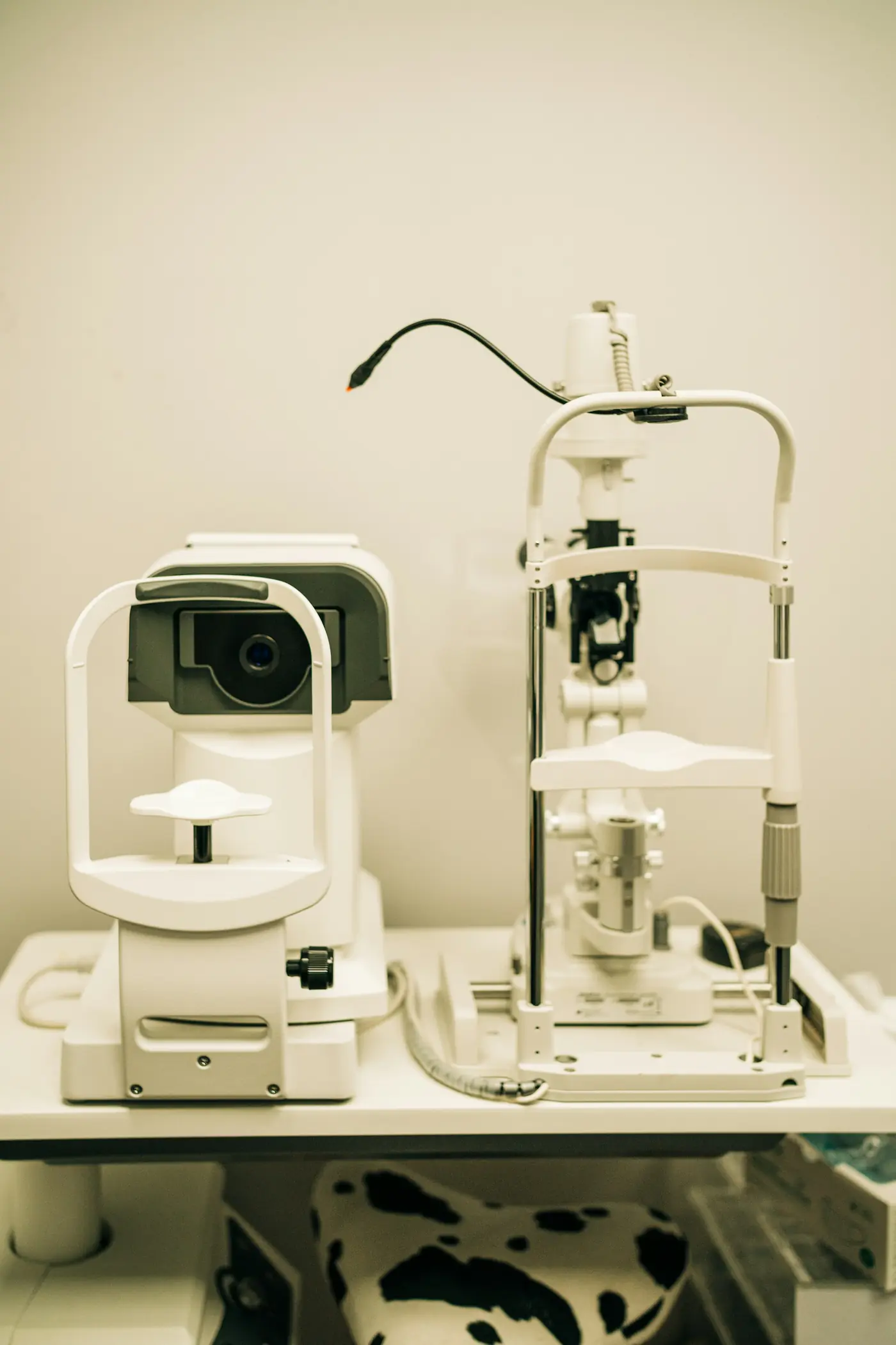A slit lamp and an autorefractor on an exam table