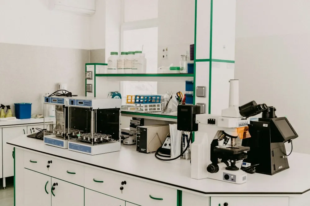 A clean laboratory bench with a microscope and instruments
