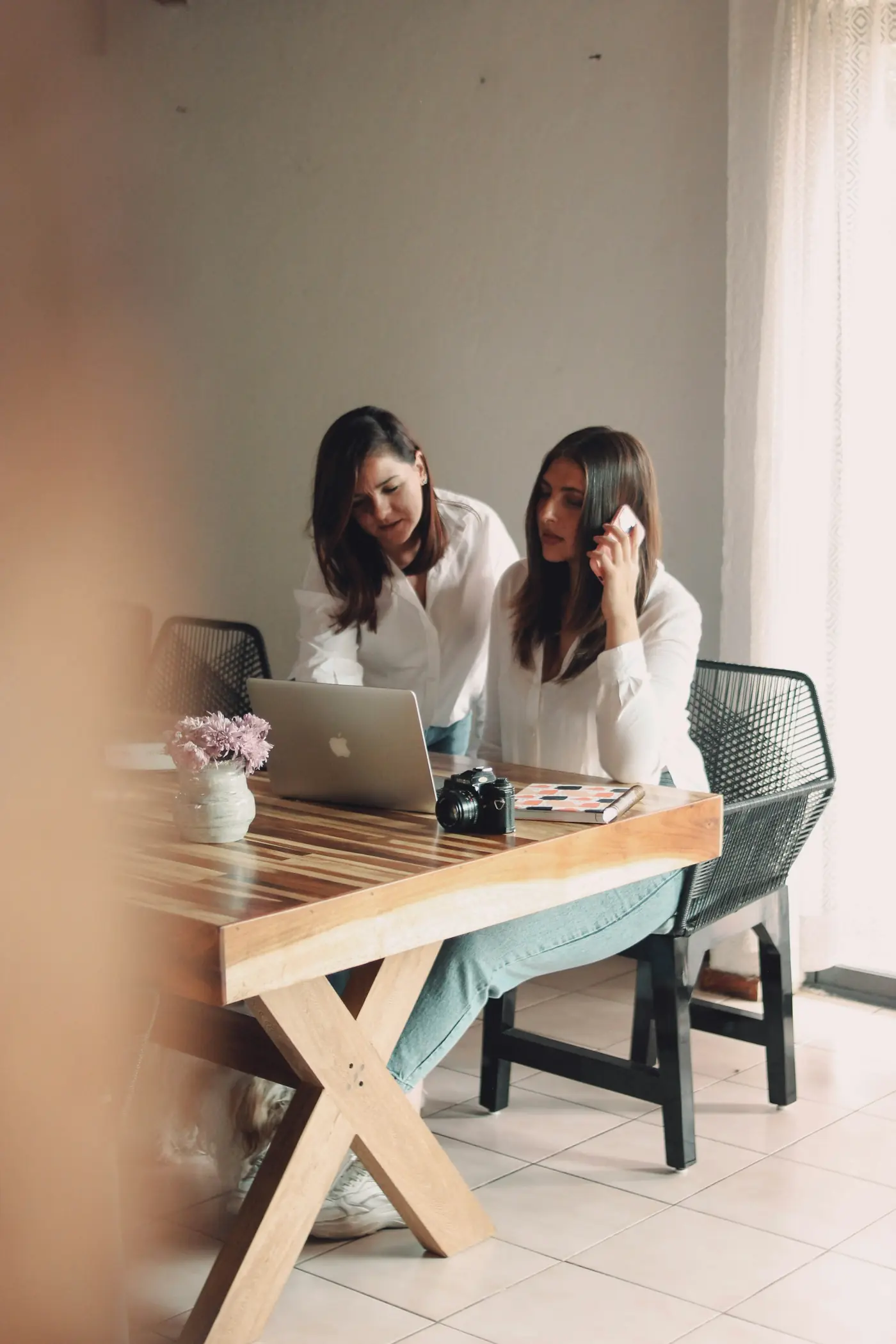 Two planners going over a plan at a laptop