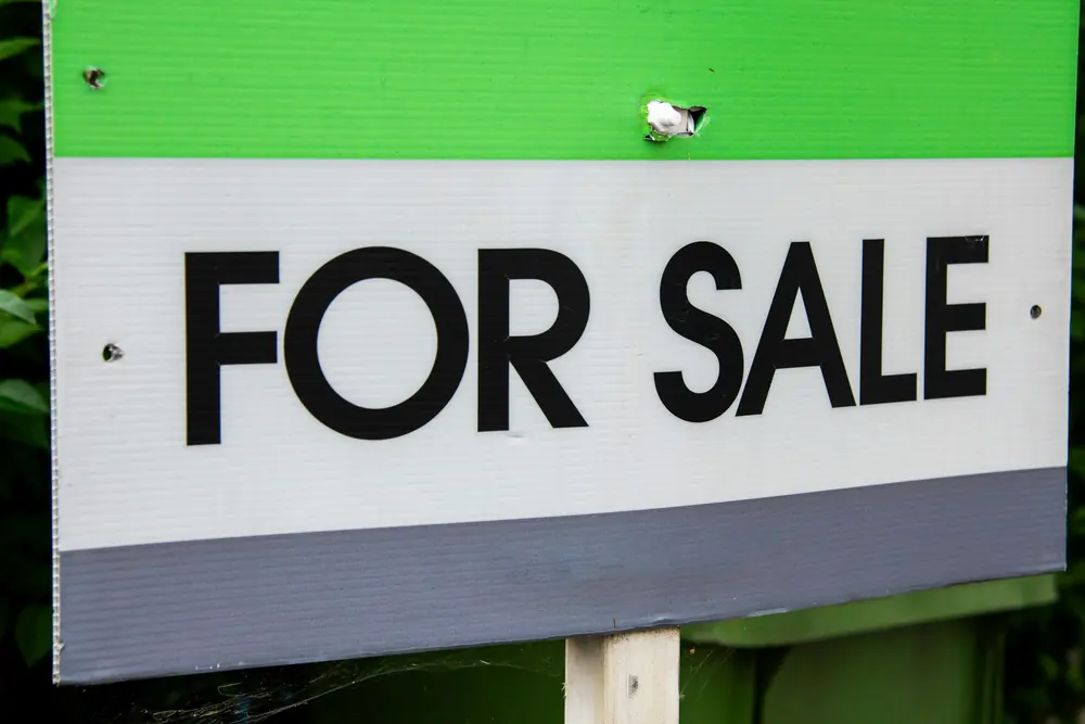 A for-sale sign in a front yard