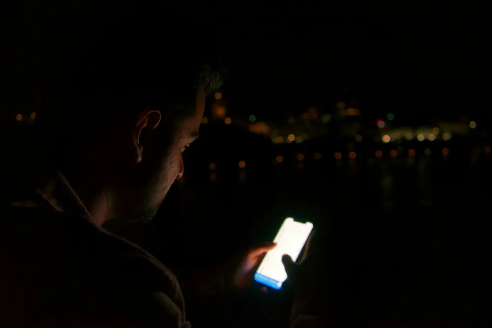 A phone screen lit up in a dark room