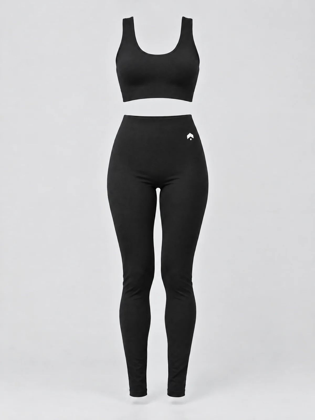 The black Brillion Studio pilates set, a seamless sports bra and high-waisted leggings, with our mark small at the front hip