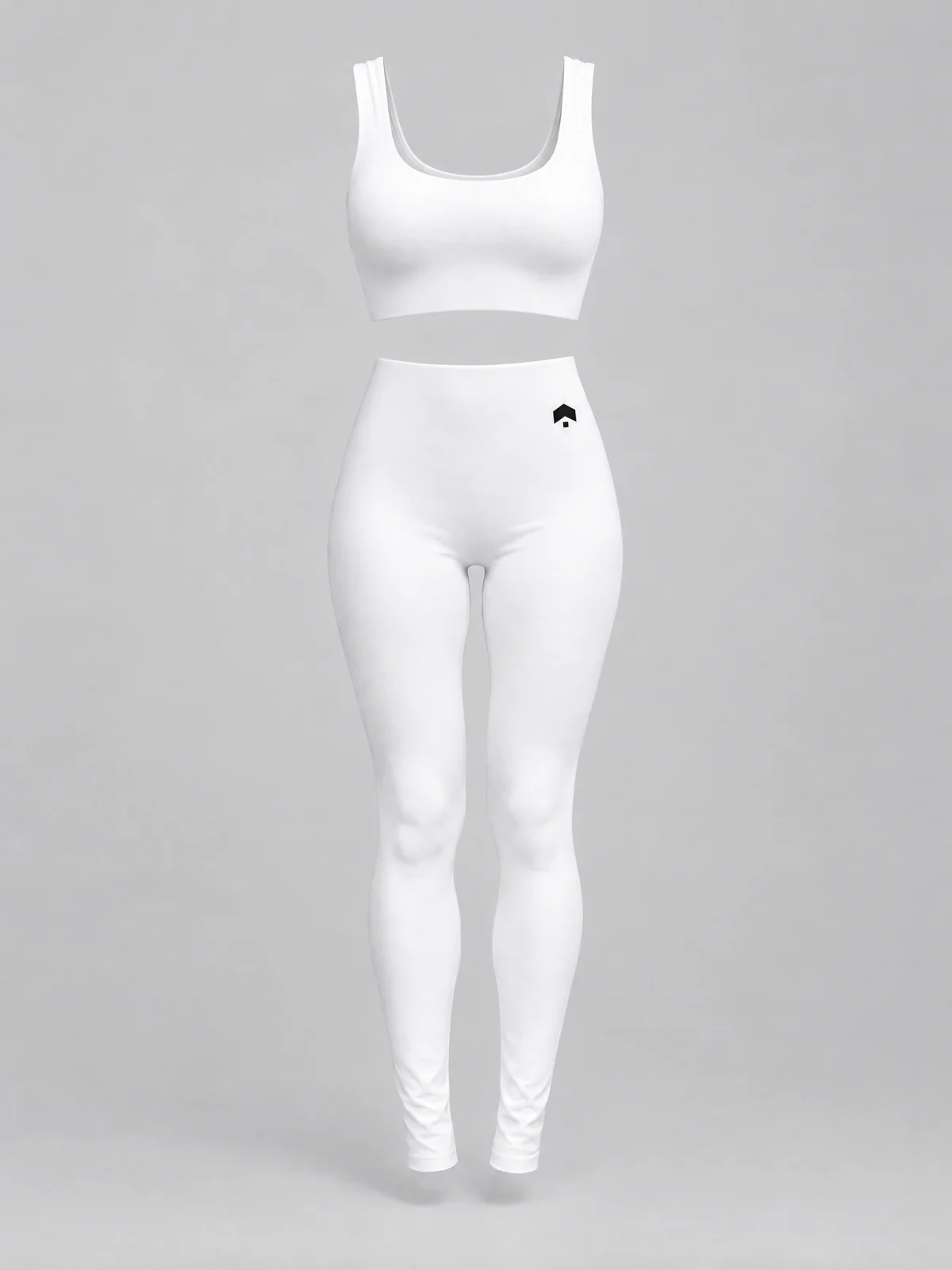 The white Brillion Studio pilates set, with our mark small in black at the front hip