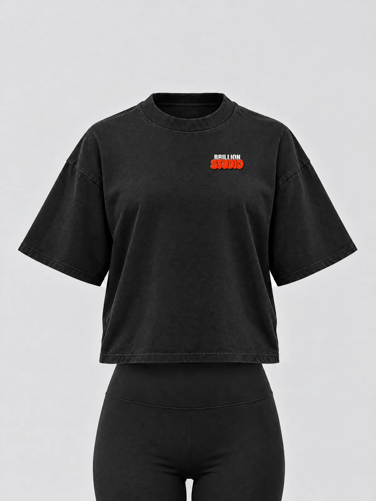 The black Brillion Studio tee on a women's form, with the STUDIO print small on the left chest