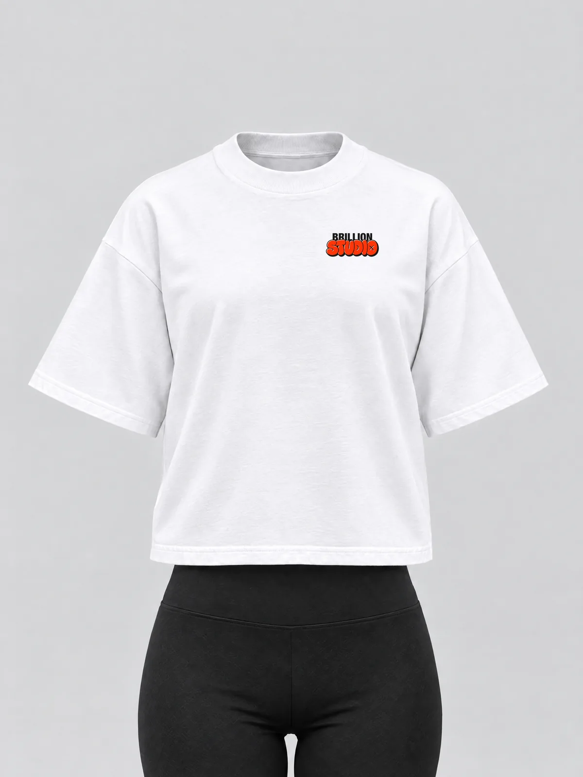The white Brillion Studio tee on a women's form, with the STUDIO print small on the left chest