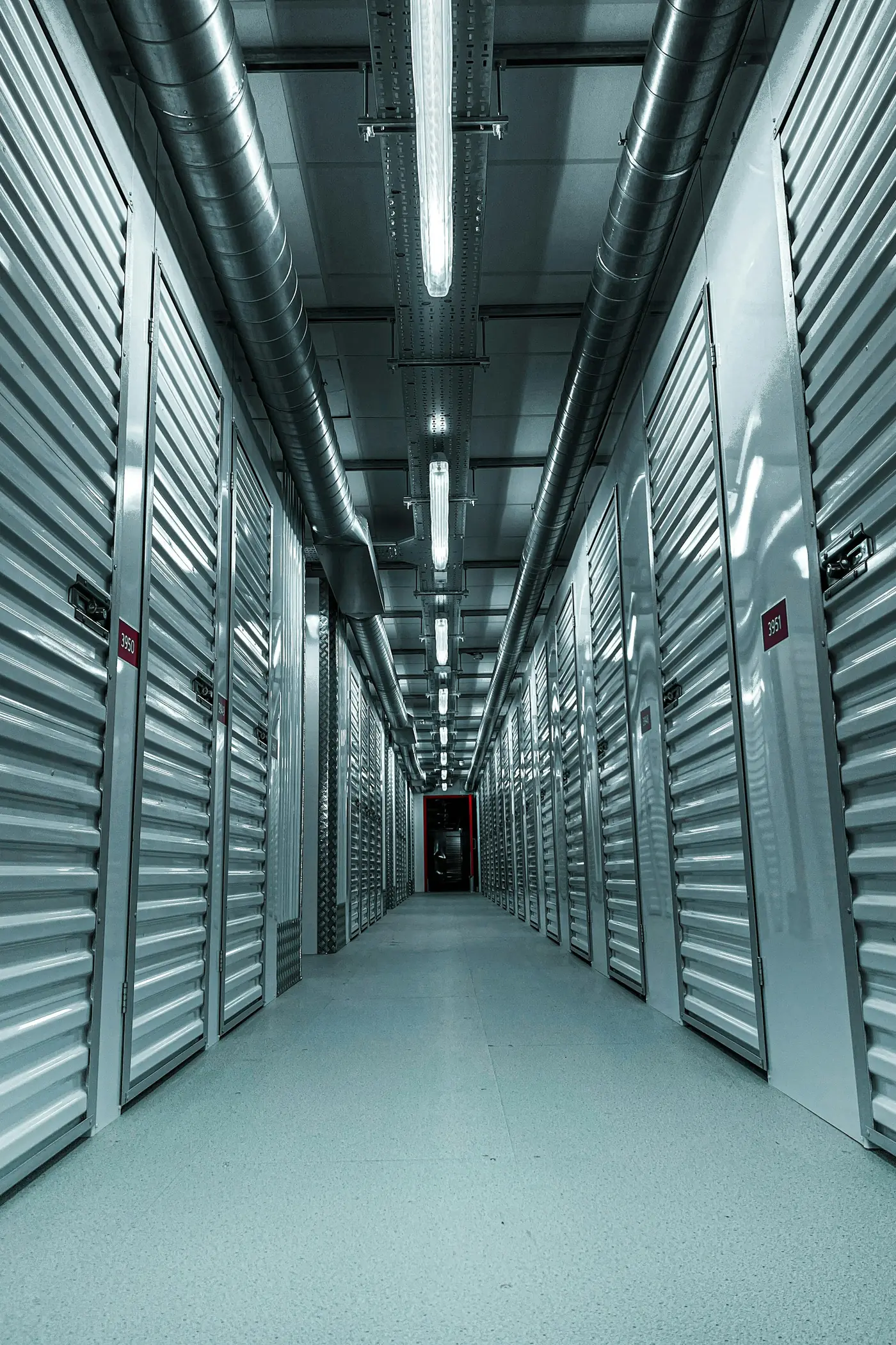 An indoor aisle of metal unit doors