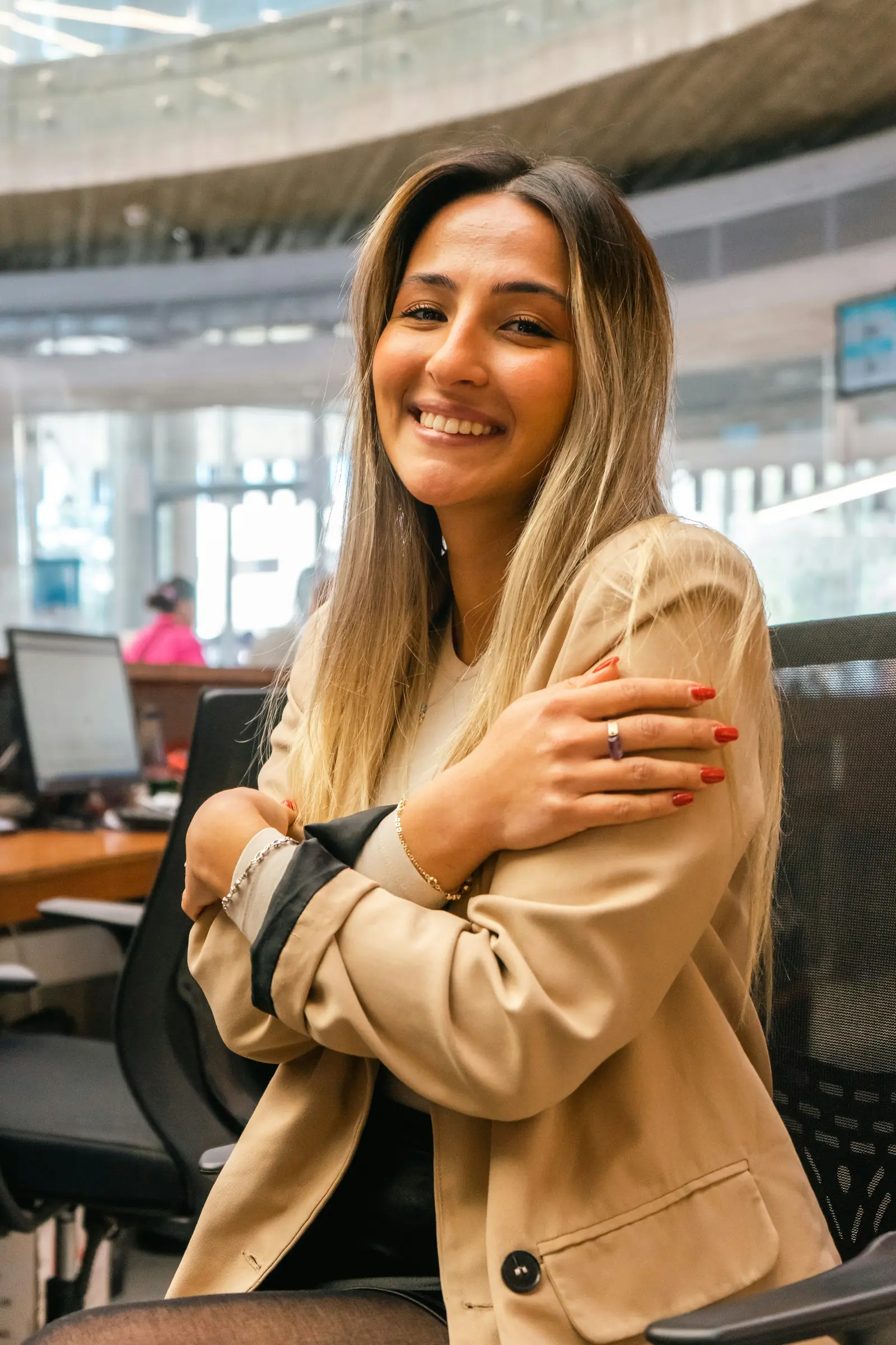 A smiling woman in an office chair