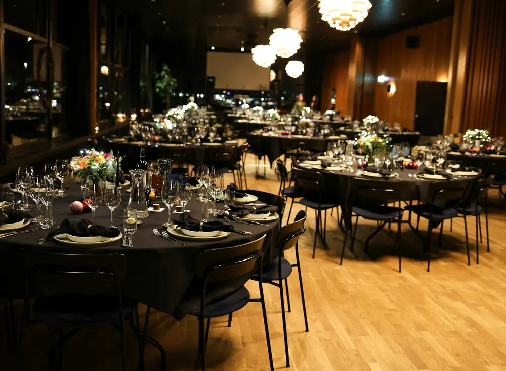 A banquet hall set for dinner with no guests